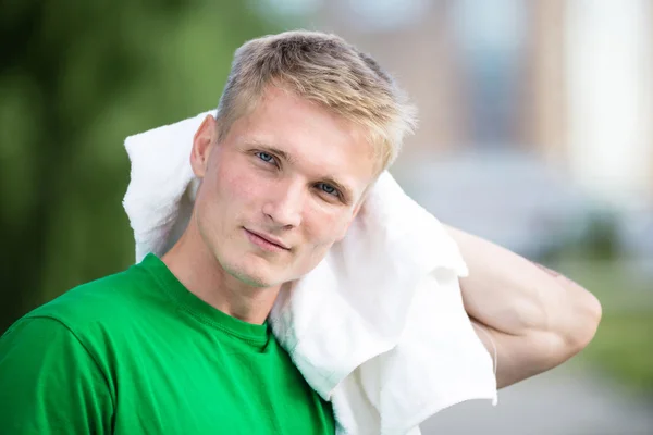 Tired man after fitness time and exercising. With white towel — Stock Photo, Image