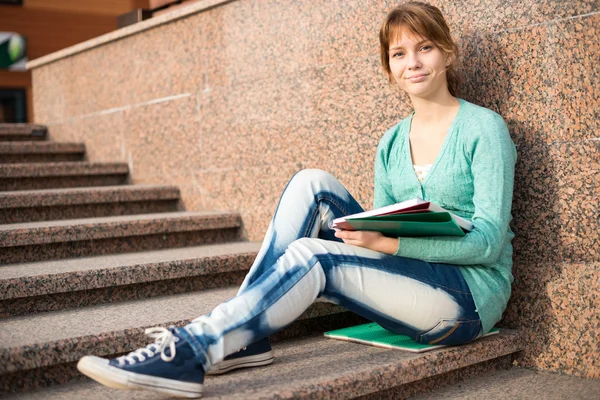 Meisje, zittend op een trap en lezen van de opmerking — Stockfoto