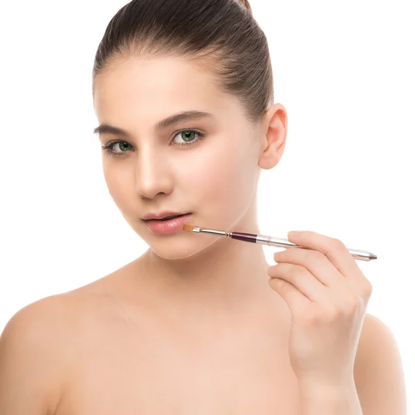 Young brunette woman with clean face. Girl perfect skin applying cosmetic brush. Isolated on a white. — Stock Photo, Image