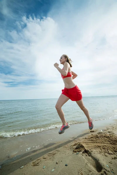 Young lady running at the sunny summer sand beach. Workout.  Jog — Stock Photo, Image