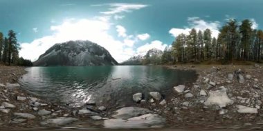 Dağ Gölü 'nün kış zamanı 360 Vr. Vahşi doğa ve dağ vadisi. Çam ağaçlarından yeşil orman ve gökyüzünde hızlı bulutlar.