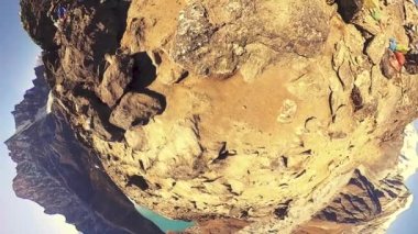 360 VR Gokyo Ri dağ tepesi. Tibet Budist bayrağı. Vahşi Himalayalar yüksek irtifa doğa ve dağ vadisi. Buzla kaplı kayalık yamaçlar. Küçük gezegen dönüşümü.