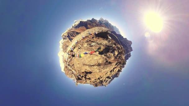 Gokyo Ri mountain top. Tibetan prayer Buddhist flag. Wild Himalayas high altitude nature and mount valley. Rocky slopes covered with ice. Tiny planet transformation movement — Stock Video