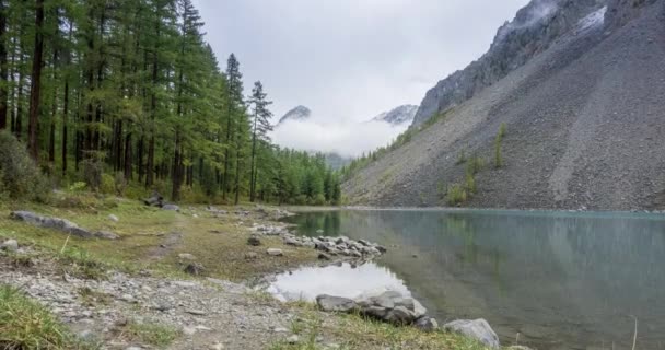 Mountain lake timelapse at the summer or autumn time. Wild nature and rural mount valley. Green forest of pine trees and fast clouds on sky. Motorised dolly slider movement — Stock Video