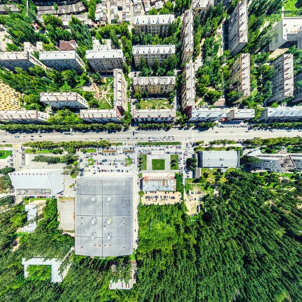 Uitzicht op de stad vanuit de lucht met kruispunten en wegen, huizen, gebouwen, parken en parkeerplaatsen. Zonnige zomer panoramisch beeld — Stockfoto