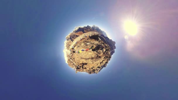 Gokyo Ri mountain top. Tibetan prayer Buddhist flag. Wild Himalayas high altitude nature and mount valley. Rocky slopes covered with ice. Tiny planet transformation movement — Stock Video