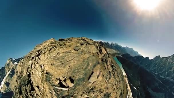 360 VR Gokyo Ri mountain top. Tibetan prayer Buddhist flag. Wild Himalayas high altitude nature and mount valley. Rocky slopes covered with ice. Tiny planet transformation. — Stock Video