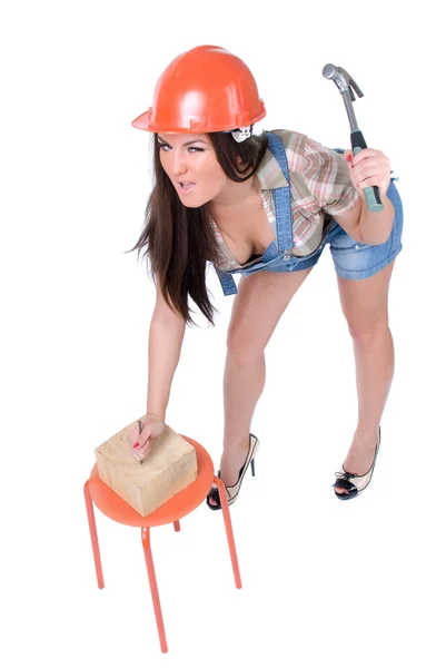Young woman holding hammer and nail — Stock Photo, Image