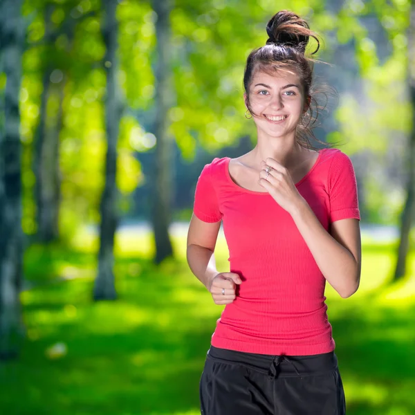 Frau läuft im grünen Park ins Freie — Stockfoto