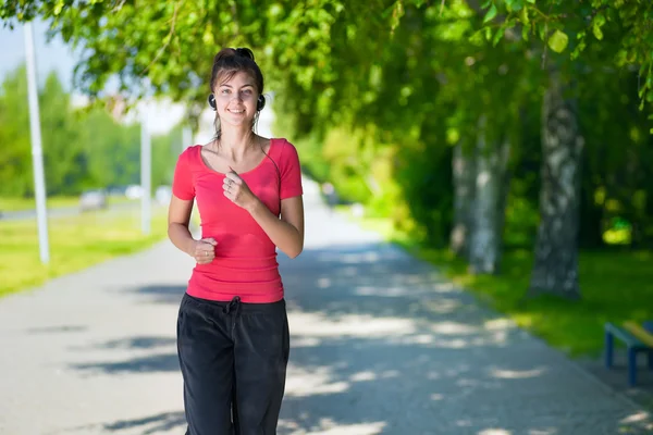 Mujer corriendo al aire libre en el parque verde — Foto de Stock