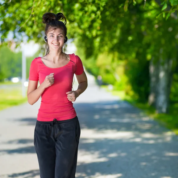 Woman running outdoors in green park — Stock Photo, Image