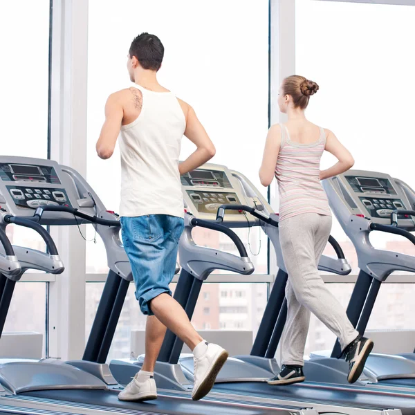 Woman and man at gym exercising. — Stock Photo, Image