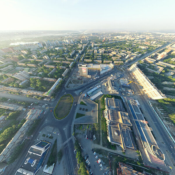 Aerial city view with crossroads, roads, houses, buildings, parks, parking lots, bridges