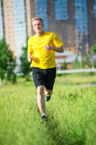 Sporty man jogging in city street park. — Stock Photo, Image