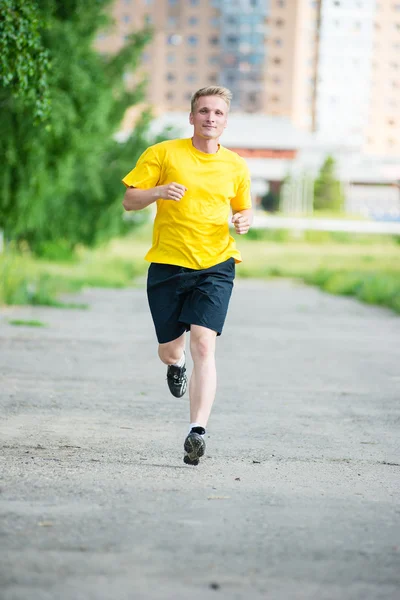 Sportieve man joggen in straat skyline van de stad. Buiten fitness. — Stockfoto