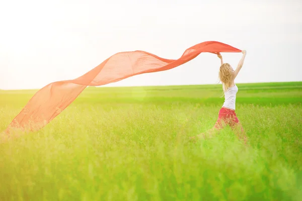 Lady runing with tissue in green field — Stock Photo, Image