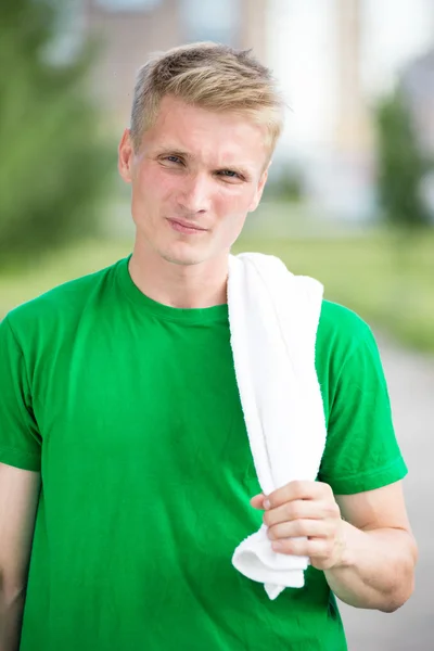 Tired man after fitness time and exercising. With white towel — Stock Photo, Image