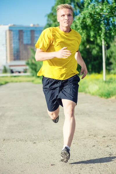 Sporty man jogging in city street park. — Stock Photo, Image