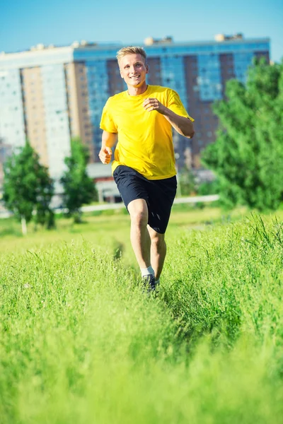 Sportieve man joggen in straat skyline van de stad. Buiten fitness. — Stockfoto