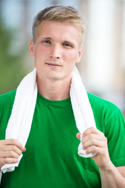 Tired man after fitness time and exercising. With white towel — Stock Photo, Image