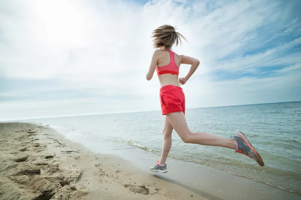 Young lady running at the sunny summer sand beach. Workout.  Jog — Stock Photo, Image