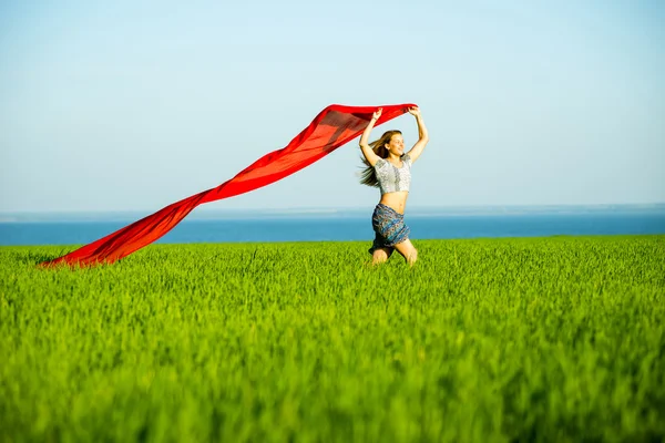 Giovane donna felice nel campo di grano con tessuto. Stile di vita estivo — Foto Stock