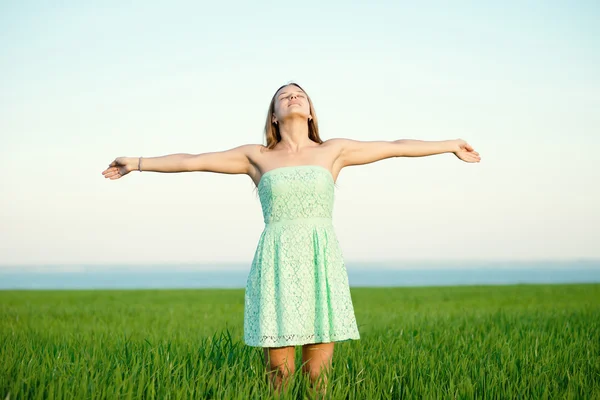 Счастье женщина оставаться на открытом воздухе под солнечным светом заката — стоковое фото