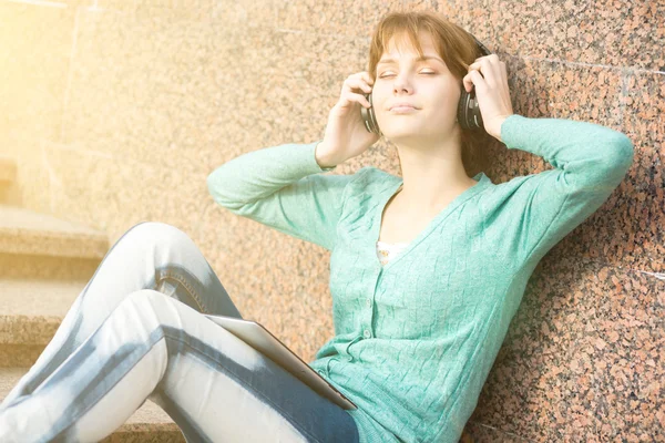 Beautiful young woman student with headphones. Outdoor music girl — Stock Photo, Image