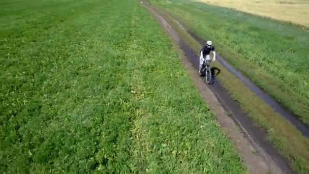 Uomo in bicicletta su una strada rurale. Vista aerea . — Video Stock