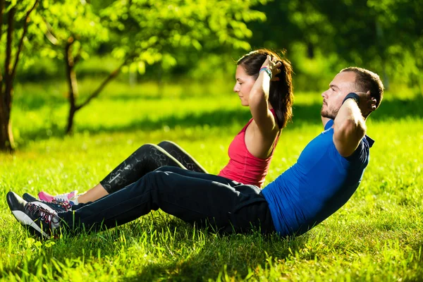 Couple exercising at the city park. Outdoor sport