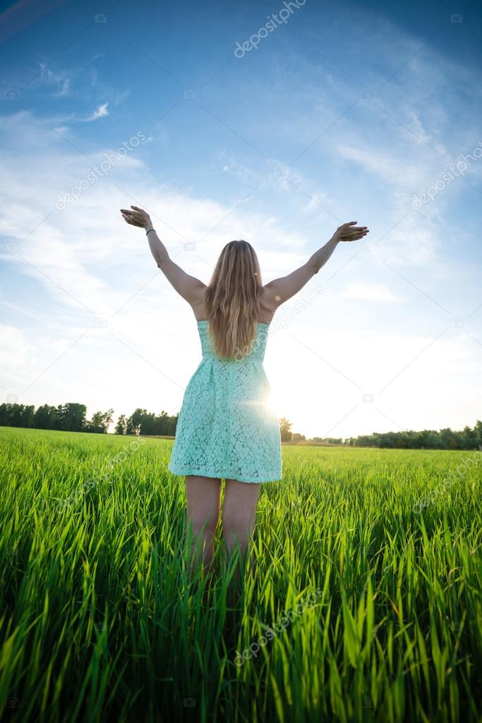 Happiness woman stay outdoor under sunlight of sunset