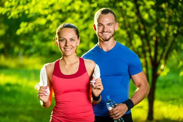 Athletic man and woman after fitness exercise