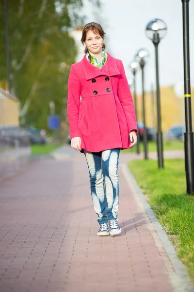 Beautiful woman in red coat walking autumn street. — Stock Photo, Image