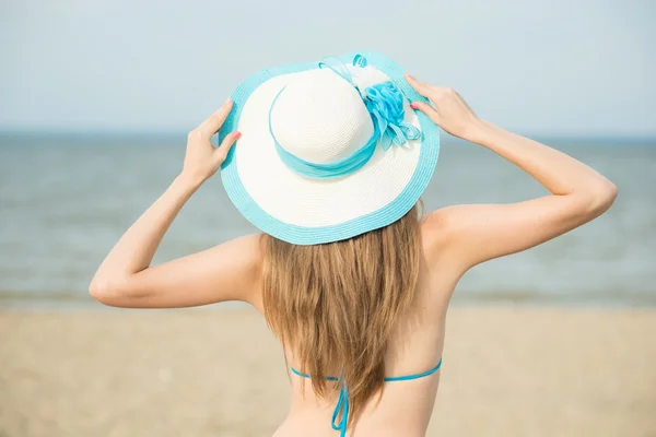 Młoda dama opalając się na plaży. Piękna kobieta pozowanie w — Zdjęcie stockowe