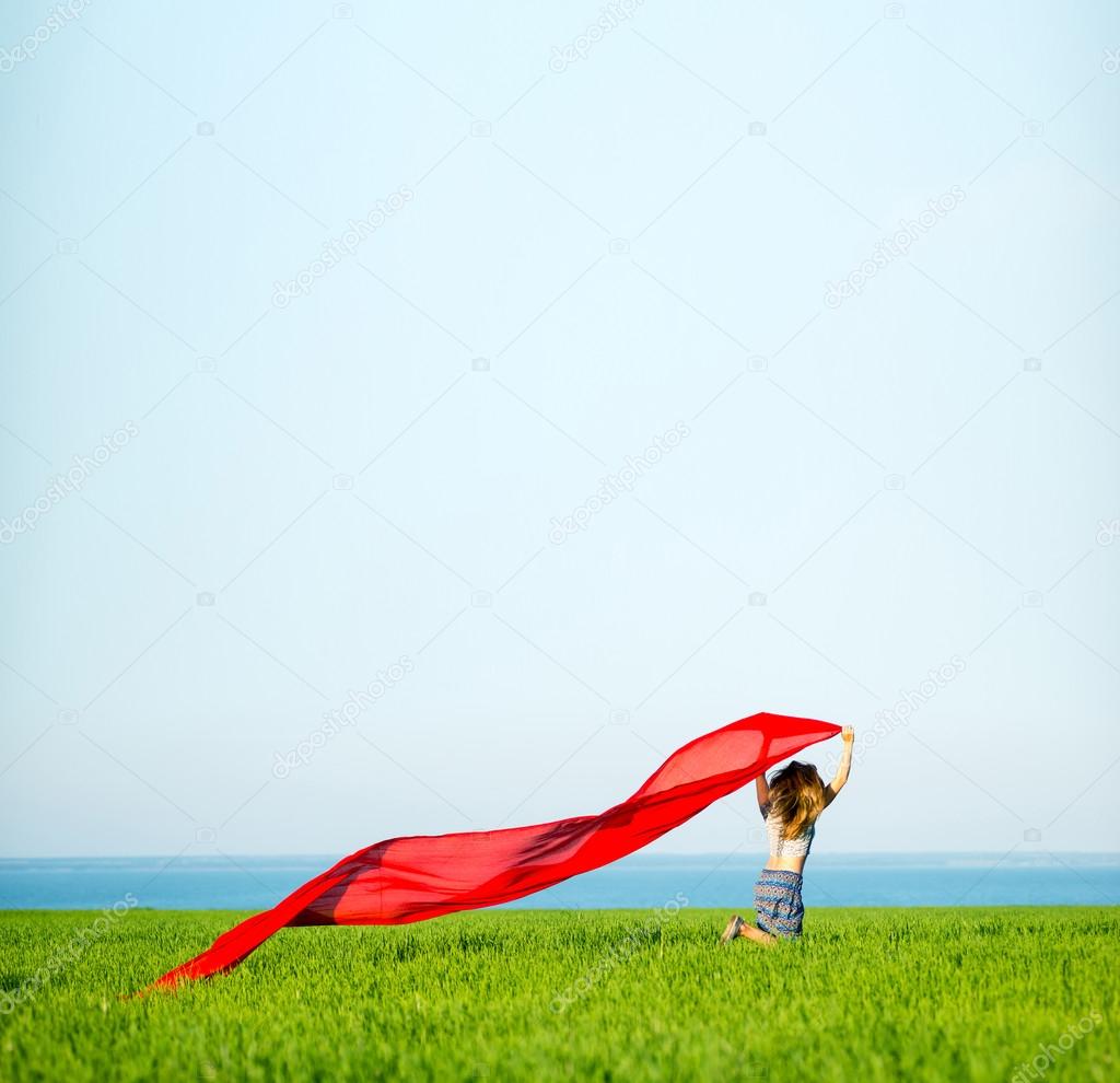 Young happy woman in wheat field with fabric. Summer lifestyle