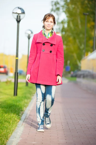 Beautiful woman in red coat walking autumn street. — Stock Photo, Image
