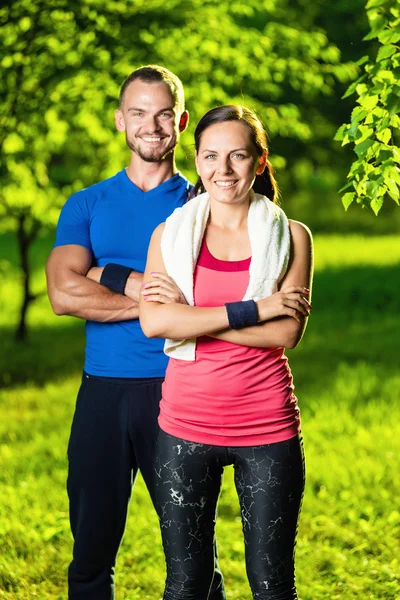 Athletic man and woman after fitness exercise — Stock Photo, Image