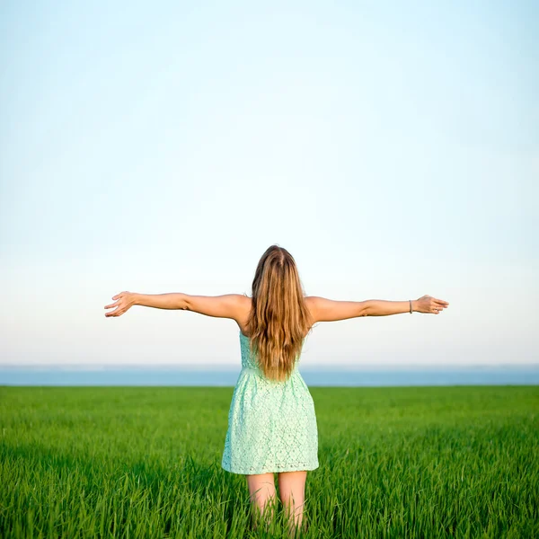 Felicidad mujer estancia al aire libre bajo la luz del sol de la puesta del sol — Foto de Stock