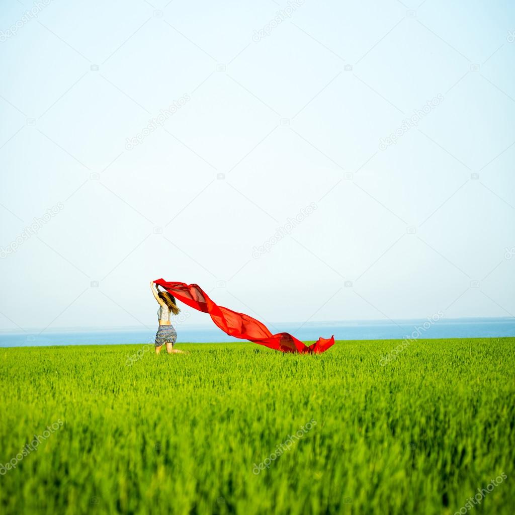 Young happy woman in wheat field with fabric. Summer lifestyle