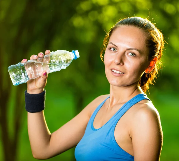 Młoda kobieta picie wody po ćwiczeniach fitness — Zdjęcie stockowe