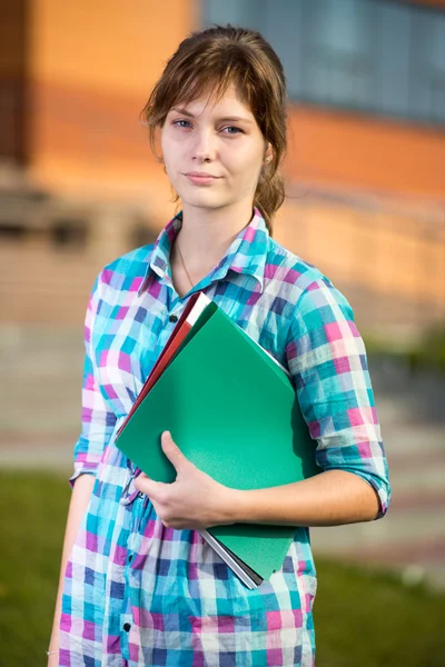 Portrait of young alluring woman holding education books. Student girl. — Stock Photo, Image