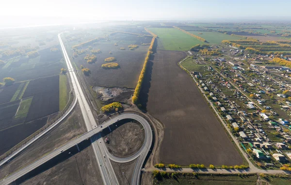 Aerial road interchange, viaduct. Crossroads view parking lots, bridges. Copter shot. Panoramic image. — Stock Photo, Image