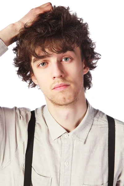 Portrait of a handsome guy in a white shirt with suspenders over — Stock Photo, Image