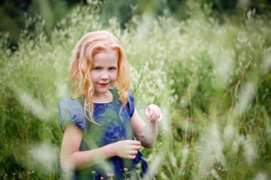 Mavi elbiseli güzel küçük kız portresi