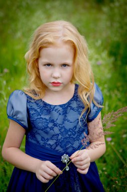 Mavi elbiseli güzel küçük kız portresi