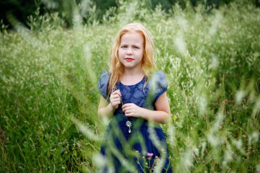 Mavi elbiseli güzel küçük kız portresi