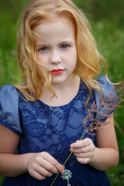 Mavi elbiseli güzel küçük kız portresi