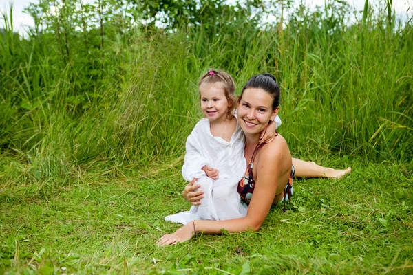 Mom and daughter are bathing in river — Stock Photo, Image