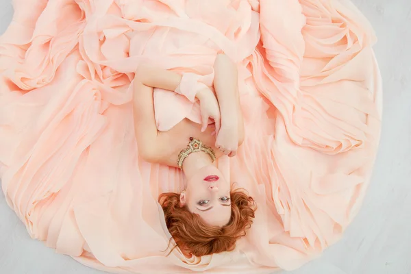 Portrait of a beautiful girl in a beige peach dress — Stock Photo, Image