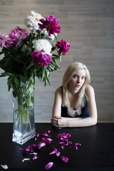 Portrait of beautiful girl blonde at table — Stock Photo, Image